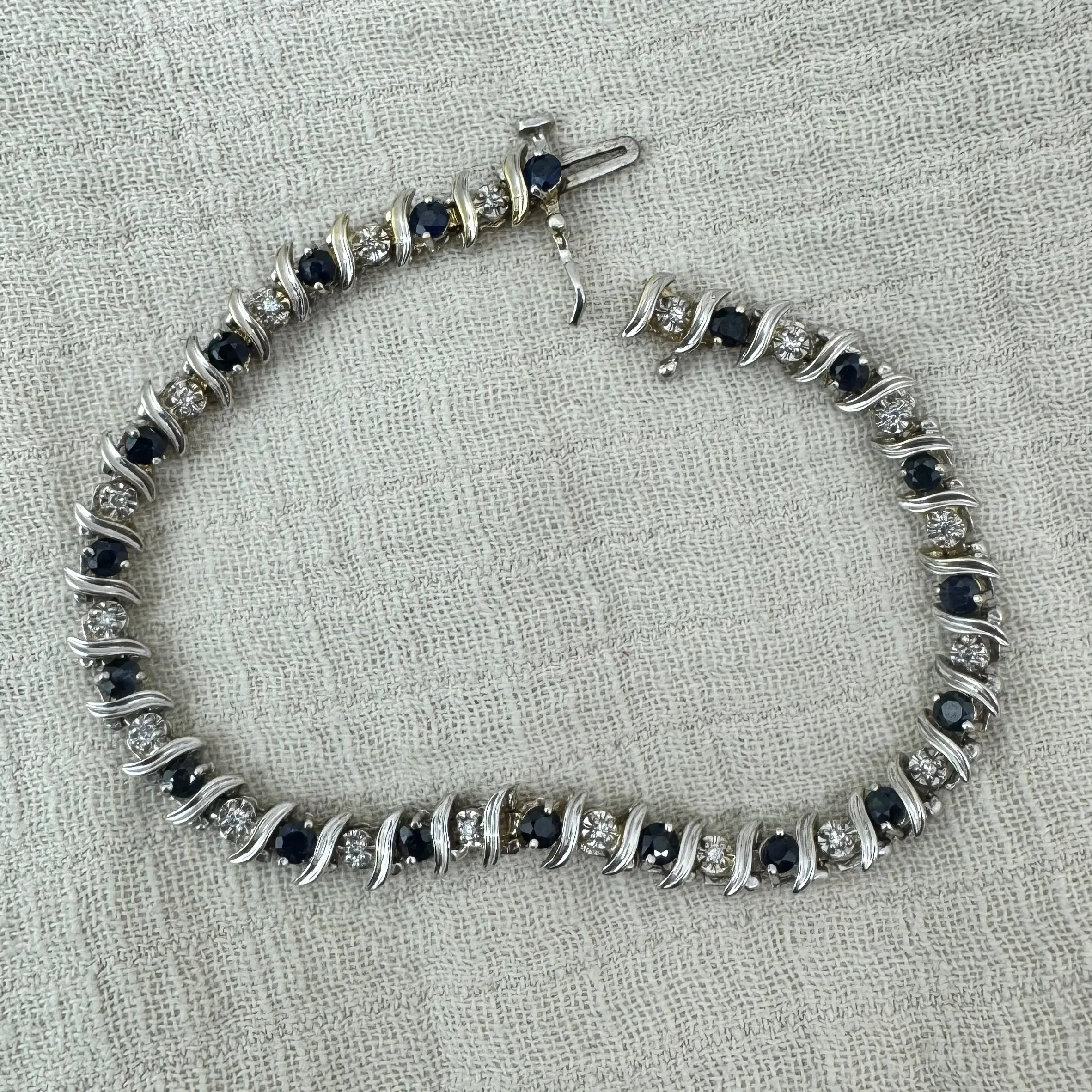14K gold bracelet set with alternating deep blue Sapphires and sparkling Diamonds