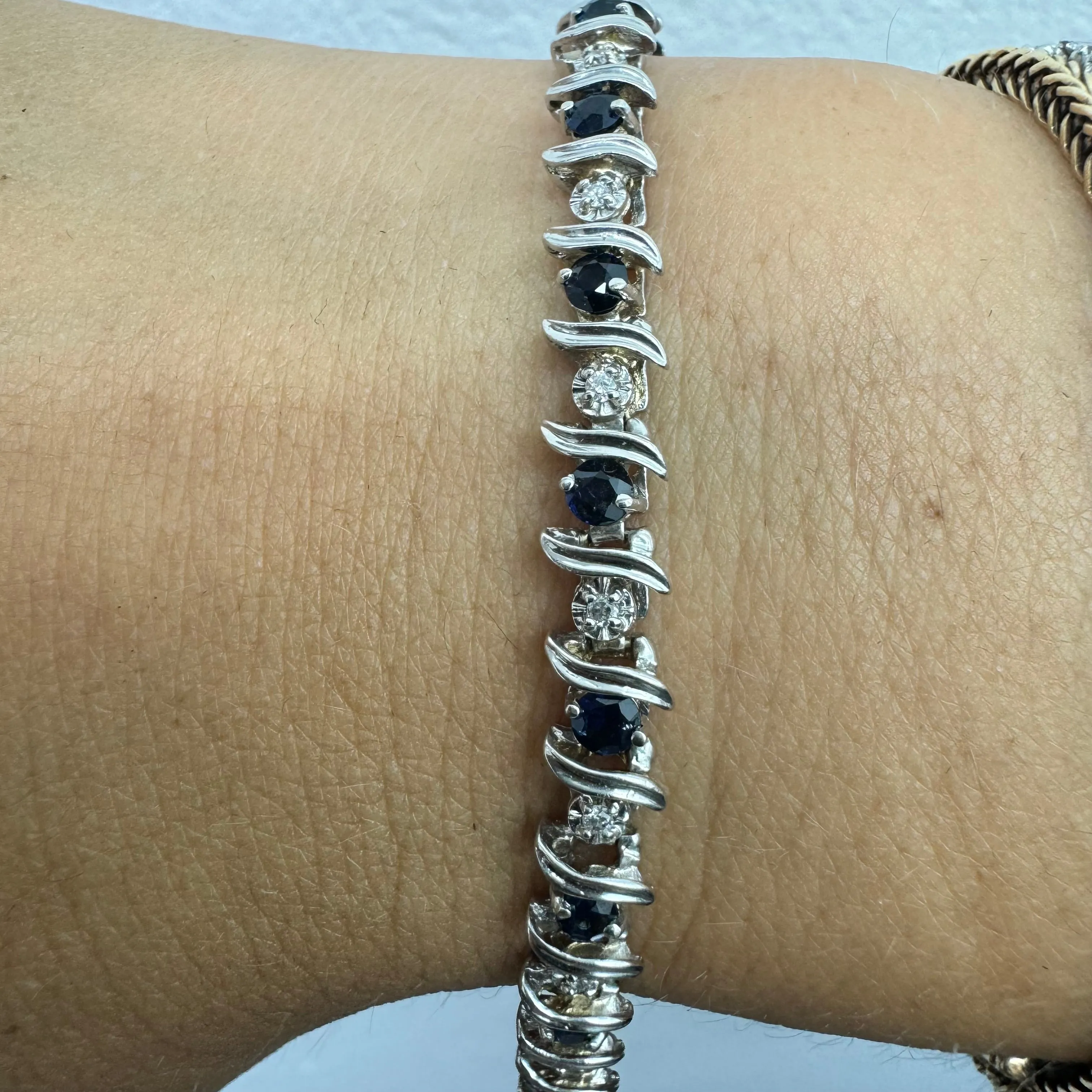 14K gold bracelet set with alternating deep blue Sapphires and sparkling Diamonds