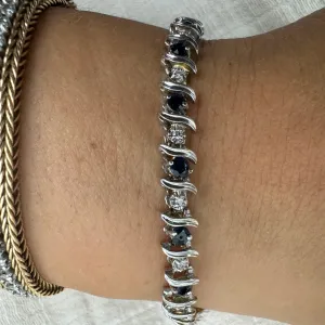 14K gold bracelet set with alternating deep blue Sapphires and sparkling Diamonds