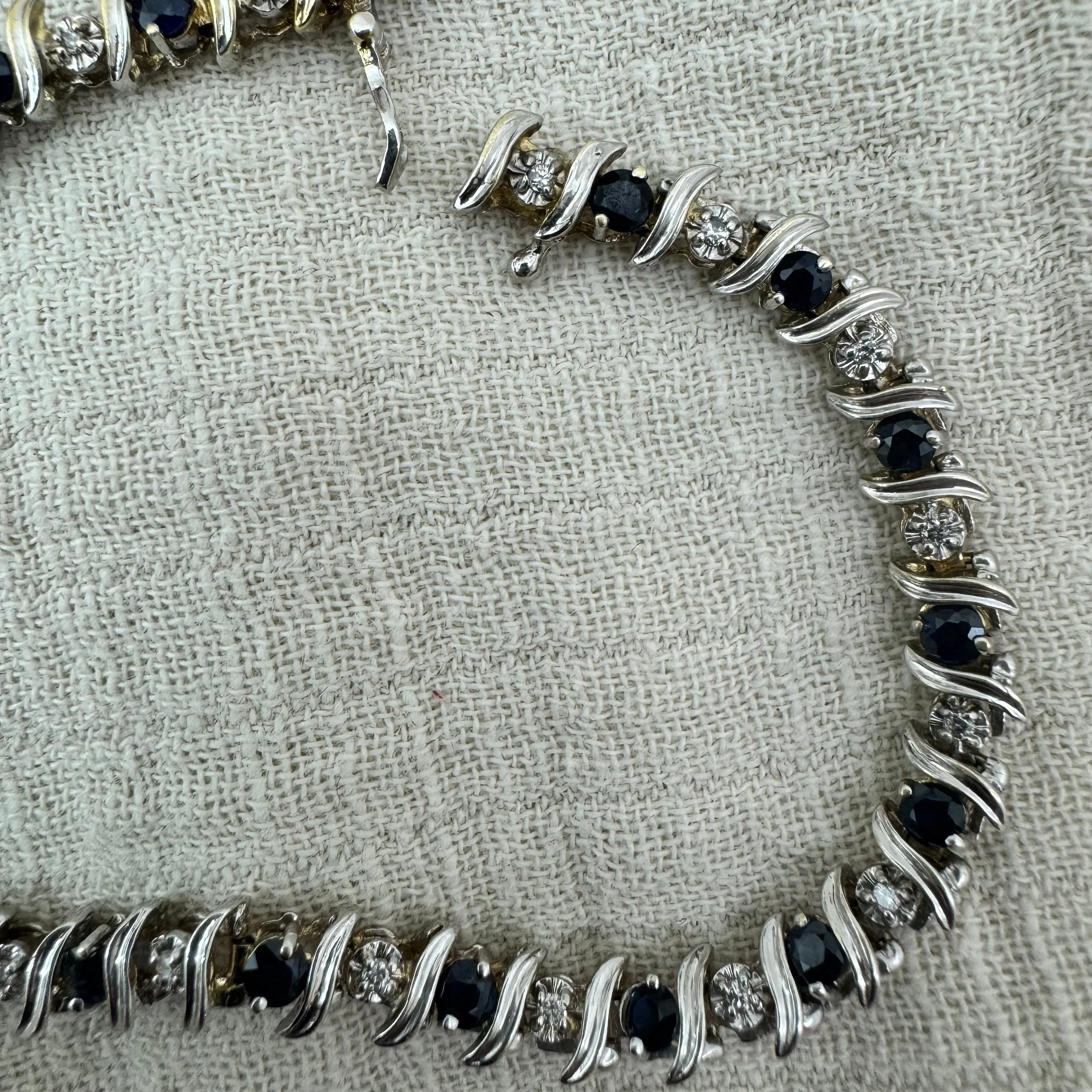 14K gold bracelet set with alternating deep blue Sapphires and sparkling Diamonds